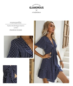 Detail of V-neckline with bow tie and polka dot pattern on a navy blue summer dress