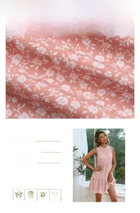 Detailed fabric view of pink floral sleeveless dress with ruffled collar and tiered hem