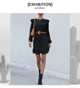 Detail shot of black long sleeve dress featuring ruffle hem and tiered skirt details