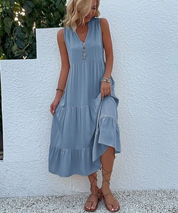 Detail view of a light blue V-neck sleeveless dress with vintage buttons and tiered skirt