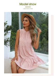 Close-up of pink floral dress with ruffle collar and tiered pleated skirt details