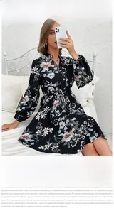 Detail of a black floral long sleeve dress with V-neckline and vintage lantern sleeves