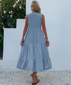 Detail of light blue tiered hem and sleeveless design on a summer maxi dress