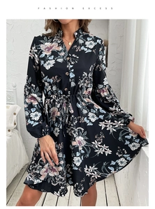 Close-up of wooden buttons and drawstring waist on black vintage floral dress