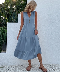 Detail view of the deep V-neckline with five buttons on a light blue tiered maxi dress