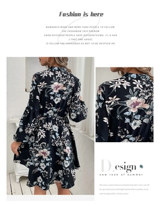 Close-up of elegant floral print on black long sleeve dress with vintage collar detail