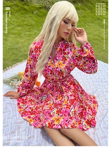 Détail d'une robe fleurie en mousseline rouge avec col à volants et lien à la taille