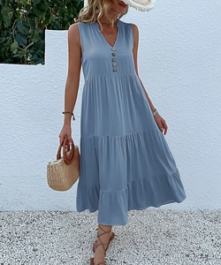 Detail of light blue V-neck dress featuring tiered skirt and rustic wood buttons