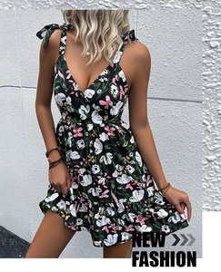 Detail of floral mini dress featuring adjustable shoulder bows and a ruffled hemline
