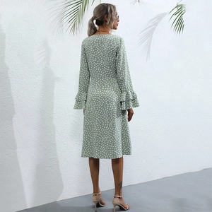 Elegant light green long-sleeved midi dress with white polka dots and ruffle cuffs
