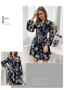 Detail of a black floral V-neck dress with long lantern sleeves and a waist tie belt