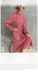 Detail of red floral midi dress showing high ruffled neck and elastic cuffs on a model