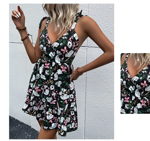 Detailed view of black floral mini dress with tie straps and ruffled hem design