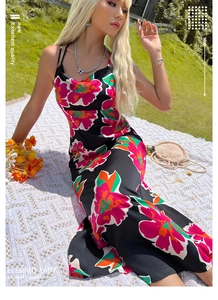 Detail of floral print maxi dress with draped neckline on a summer picnic blanket