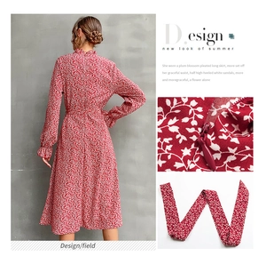 Detail of red floral dress showing invisible back zipper and high ruffle neckline