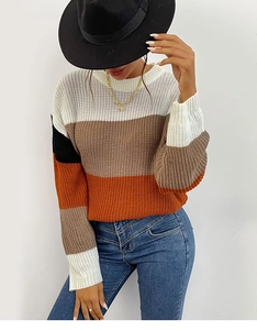 Detail of chunky knit sweater with wide horizontal stripes in white, brown and orange