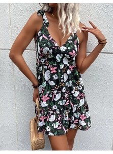 Close-up of adjustable bow shoulder straps and V-neckline on floral summer dress