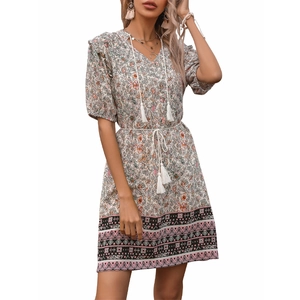 Floral V-neck mini dress with puff sleeves and white tassel belt on a beige background