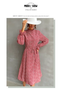 Detailed view of red floral midi dress featuring ruffled high neck and waist tie details