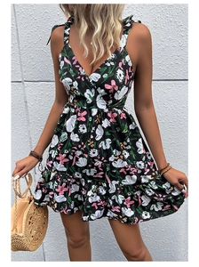 Detail of summer floral dress with delicate tie straps, V-neck, and pink flower print