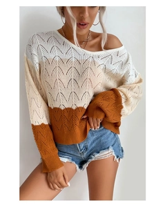 Close-up of color-block knit sweater featuring wave pattern and hollow texture detail