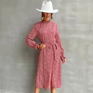 Elegant red floral midi dress with high neck and waist tie shown on professional model