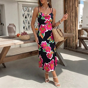 Summer halter neck midi dress with vibrant pink floral print on black fabric