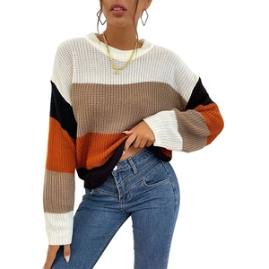 Women's oversized striped knit sweater in colorblock pattern of white, brown, and orange