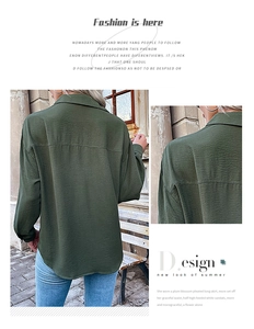 Detail view of dark green long sleeve shirt with textured fabric and stylish curved hemline