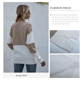 Detailed view of color-block knit sweater showing ribbed cuffs and beige stitching