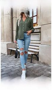 Detail of army green long sleeve shirt with chest pockets and button-down front texture