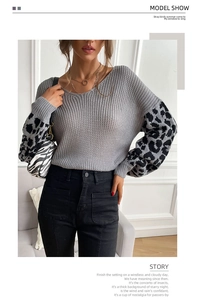 Detail of grey V-neck knit sweater with leopard print sleeves and loose casual fit