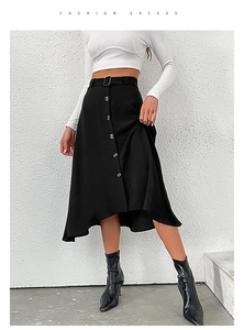 Detail of black A-line skirt with amber buttons, belt and irregular hemline