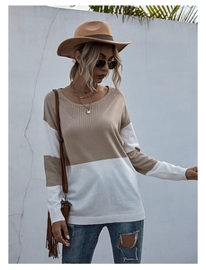 Detail of V-shaped mesh hollow collar on a beige and white color block knitted sweater