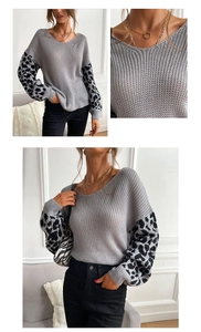 Detail of grey chunky knit sweater with leopard print sleeves and V-neckline texture