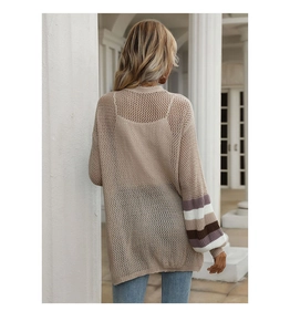 Detail of hollow knit texture and colorful striped cuffs on a beige women cardigan