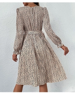 Detailed back view of leopard print dress featuring a tied waist and pleated cuffs
