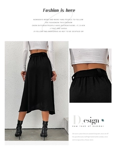 Detail view of high-waist asymmetric black skirt with invisible back zipper and texture