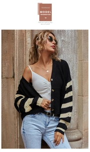Close-up of striped knit cardigan featuring vintage wooden buttons and textured ribbing