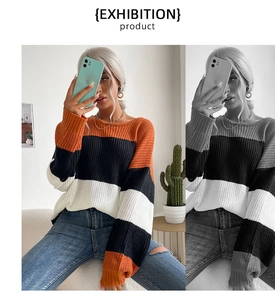 Detail of color-block striped knit sweater with orange and black wide panels and ribbed cuffs