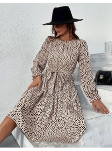 Detail of leopard print pleated dress featuring elegant waist tie and lantern sleeves