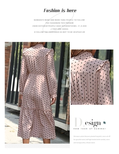 Detail of pink polka dot dress showing high neck ruffle collar and layered cake skirt style