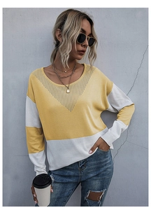 Detailed knit of yellow and white color-block sweater with V-shape cutout on crewneck