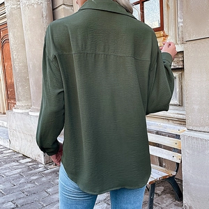 Women's dark green long sleeve shirt with back pleat detail and curved hemline