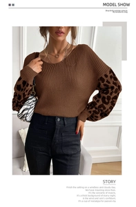 Close-up of brown knit sweater featuring leopard print patchwork sleeves and ribbed crewneck