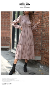 Detail of the high neck ruffle collar and elastic pleats on the pink polka dot dress