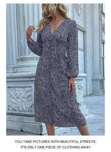 Detail of navy blue V-neck floral dress featuring a button-down front and high waist