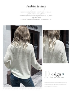 Detail of white hollow mesh knit texture and long sleeve design on a casual sweater