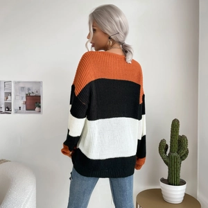 Loose fit women's knit sweater with bold orange, black, and white horizontal stripes