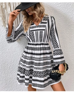 Detail of bohemian black and white geometric print dress with V-neck and flared sleeves